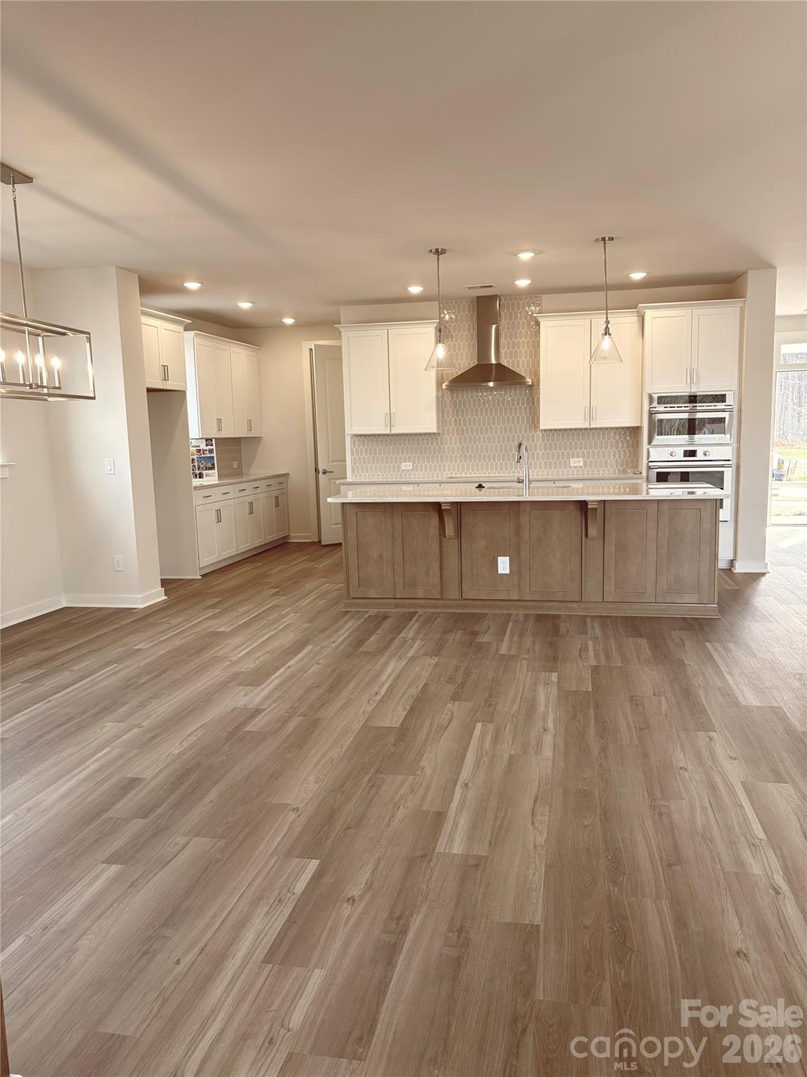 5214 Holw Br Road Charlotte, NC 28278 - Photo 7 of 17 a view of kitchen with kitchen island wooden floors wooden cabinets and stainless steel appliances