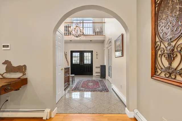 a view of an entryway with wooden floor
