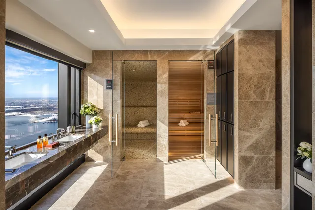 a bathroom with a glass door shower and a sink