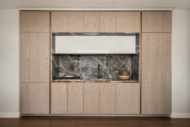 a close view of a refrigerator a sink and a cabinets
