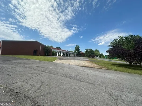 a view of the field of grass and trees