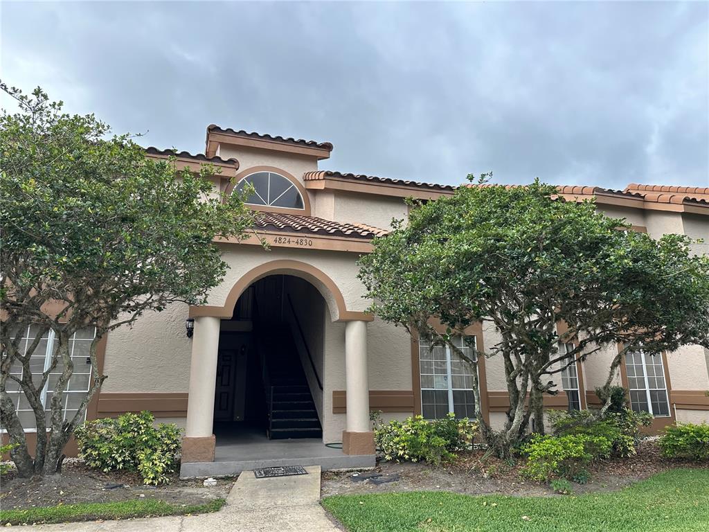 4828 Normandy Place, Unit D Orlando, FL 32811 - Photo 1 of 1 front view of a house with a garden