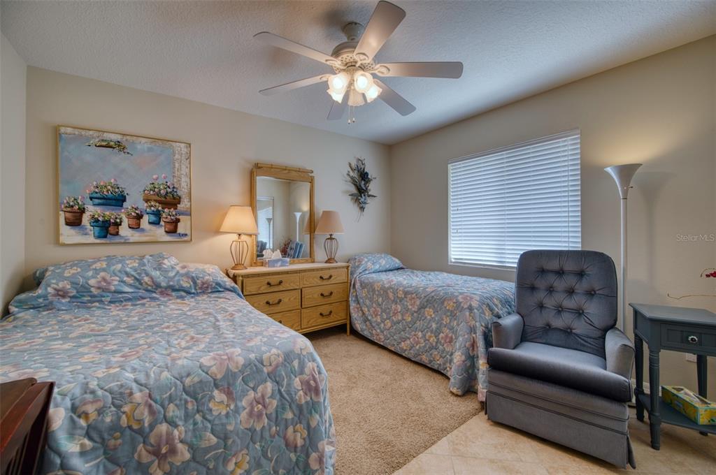 541 Falkland Road Venice, FL 34293 - Photo 14 of 22 a bedroom with a bed a couch and dresser