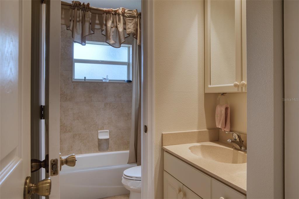 541 Falkland Road Venice, FL 34293 - Photo 15 of 22 a bathroom with a granite countertop sink toilet and shower
