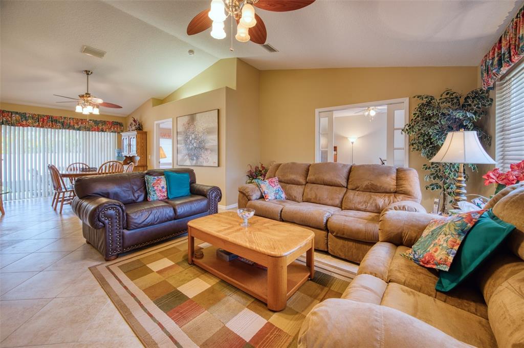 541 Falkland Road Venice, FL 34293 - Photo 3 of 22 a living room with furniture a chandelier and a couch