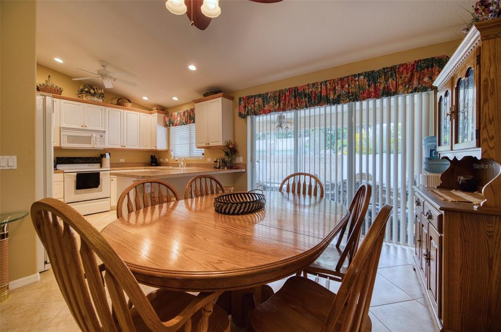 541 Falkland Road Venice, FL 34293 - Photo 5 of 22 a kitchen with stainless steel appliances granite countertop a table chairs and a refrigerator