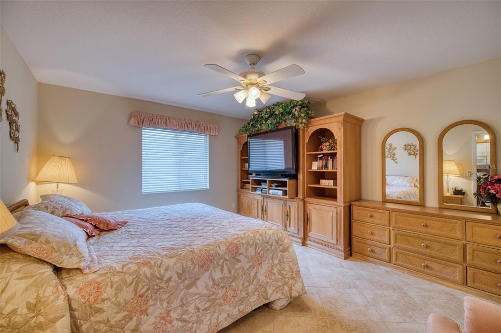 541 Falkland Road Venice, FL 34293 - Photo 7 of 22 a bedroom with a large bed and a chandelier