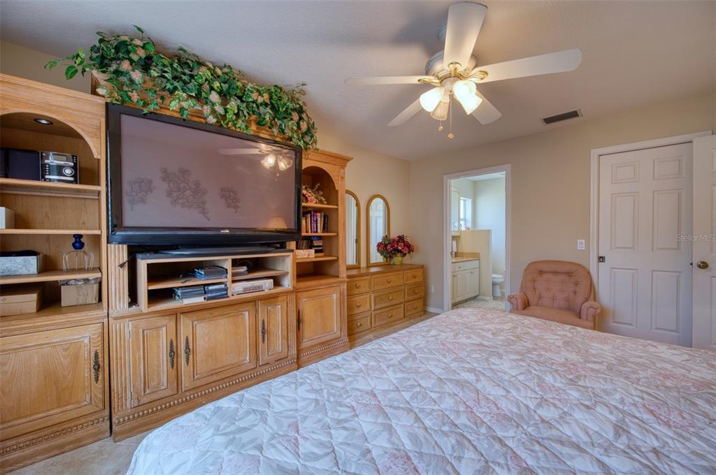 541 Falkland Road Venice, FL 34293 - Photo 8 of 22 a kitchen with stainless steel appliances kitchen island granite countertop a stove top oven a sink with wooden cabinets and floor