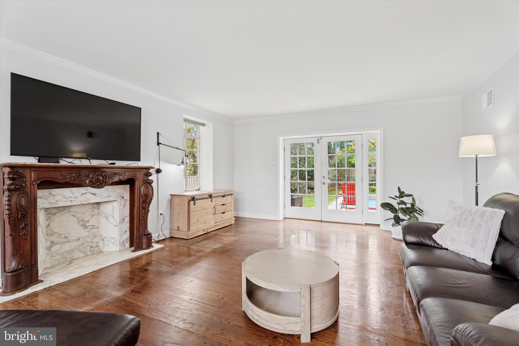 110 Raynham Road Merion Station, PA 19066 - Photo 20 of 59 a living room with furniture a flat screen tv and a fireplace