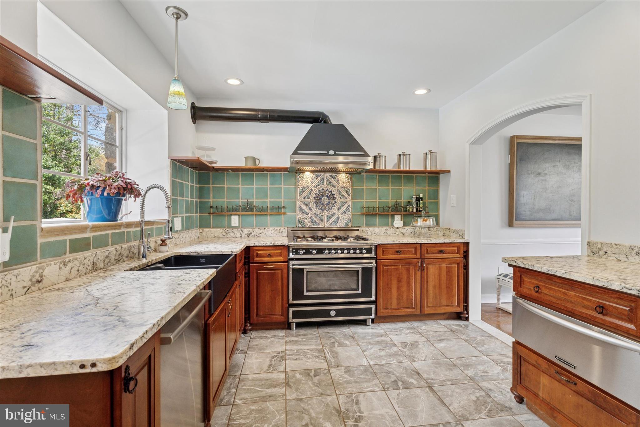 110 Raynham Road Merion Station, PA 19066 - Photo 29 of 59 a kitchen with stainless steel appliances granite countertop a stove and a sink