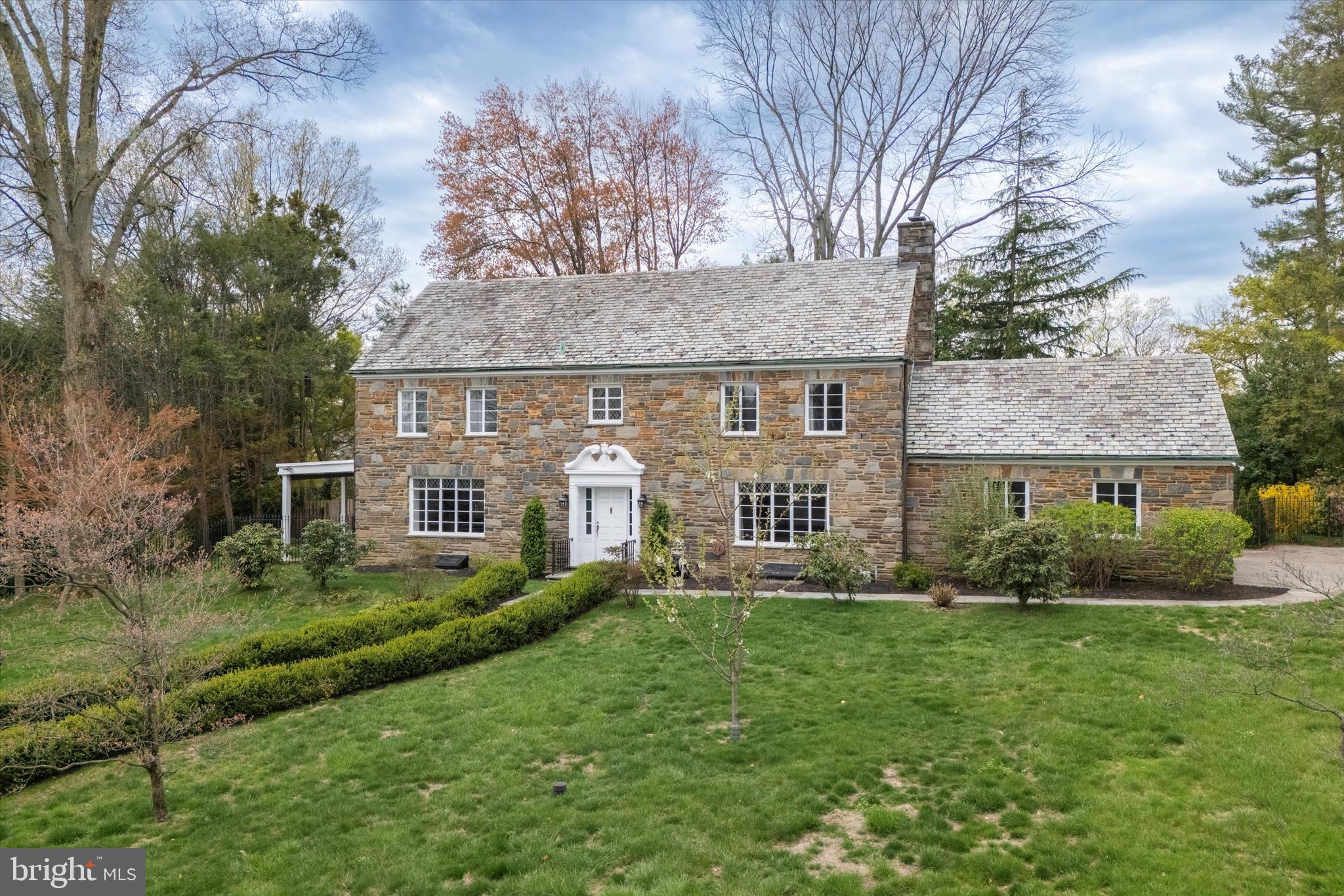 110 Raynham Road Merion Station, PA 19066 - Photo 4 of 59 a front view of a house with a yard and trees