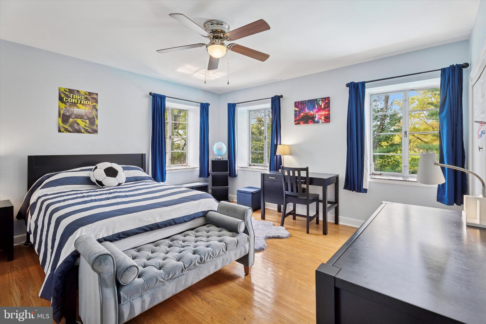 110 Raynham Road Merion Station, PA 19066 - Photo 41 of 59 a spacious bedroom with a bed a table and a large window