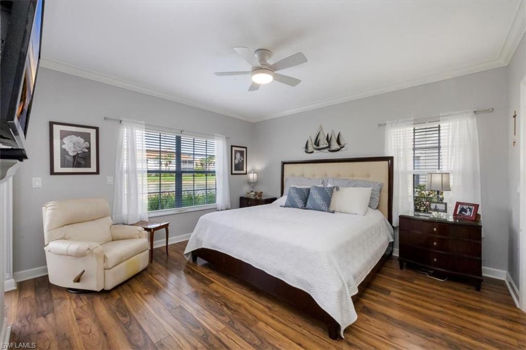 3023 Horizon Lane, Unit 2507 Naples, FL 34109 - Photo 15 of 50 a bedroom with a bed and wooden floor