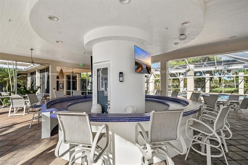 3023 Horizon Lane, Unit 2507 Naples, FL 34109 - Photo 42 of 50 a dining room with furniture a chandelier and wooden floor