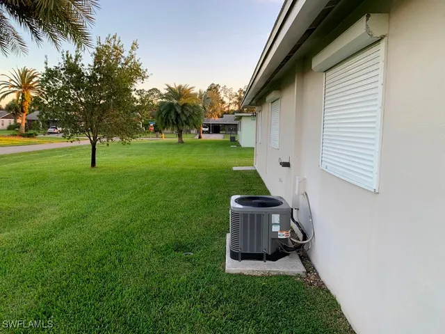 a view of an house with backyard space and garden