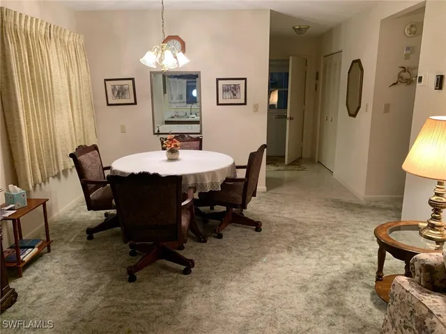 a dining room with furniture and window