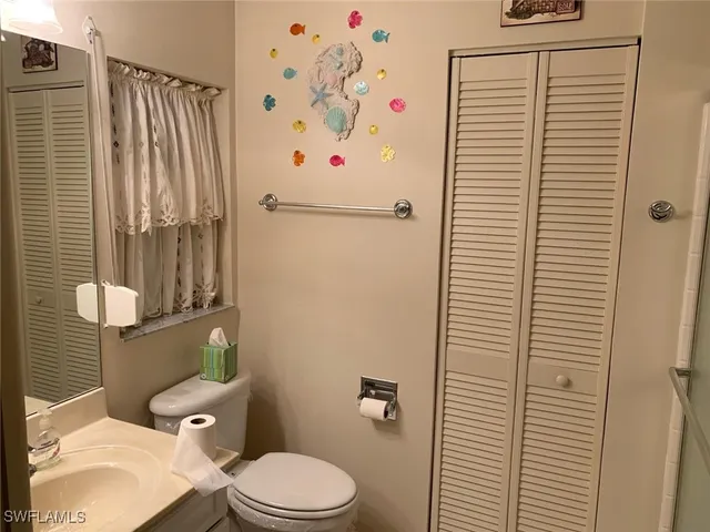 a white toilet sitting next to a bathroom sink