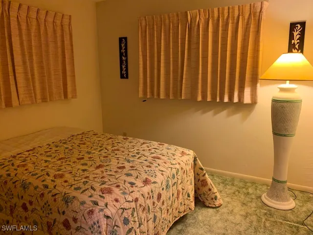 a bedroom with a bed and a chair