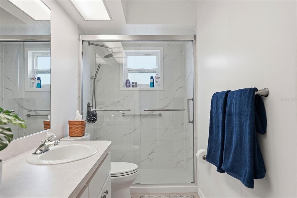 14228 Presteign Lane Spring Hill, FL 34609 - Photo 56 of 89 a bathroom with a sink a toilet and shower