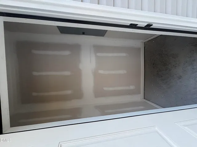 a view of an empty room and wooden floor