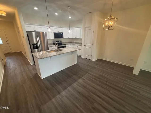 a view of kitchen with cabinets and wooden floor