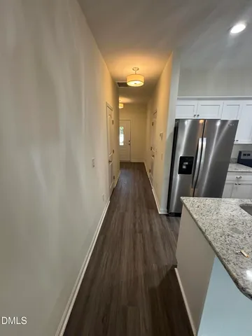 a view of a hallway with wooden floor