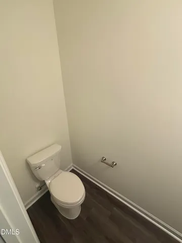 an empty room with wooden floor and window