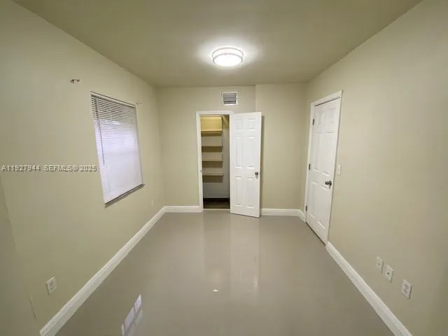 an empty room with closet and closet