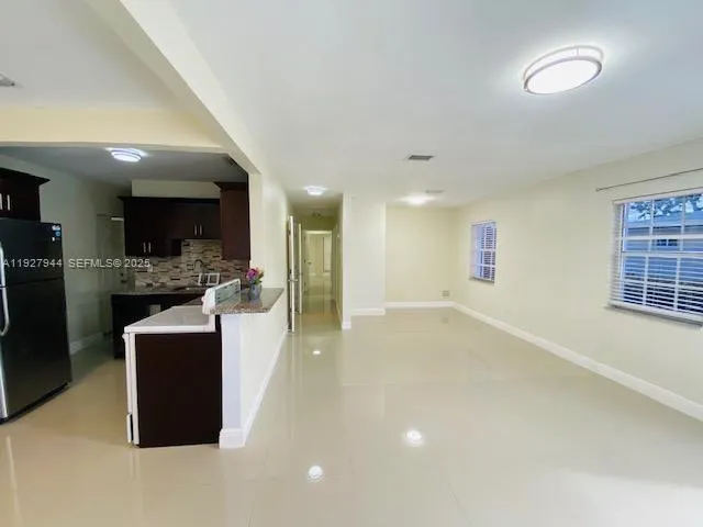 a view of kitchen with furniture and windows