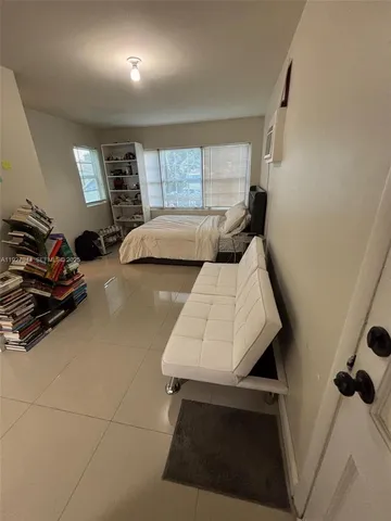 a bedroom with furniture and a window