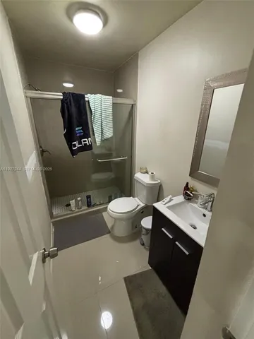a bathroom with a sink mirror and toilet