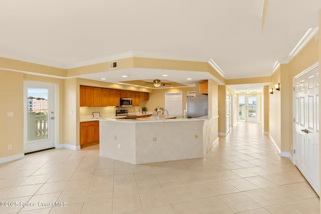 a kitchen with stainless steel appliances granite countertop a refrigerator a oven and a sink