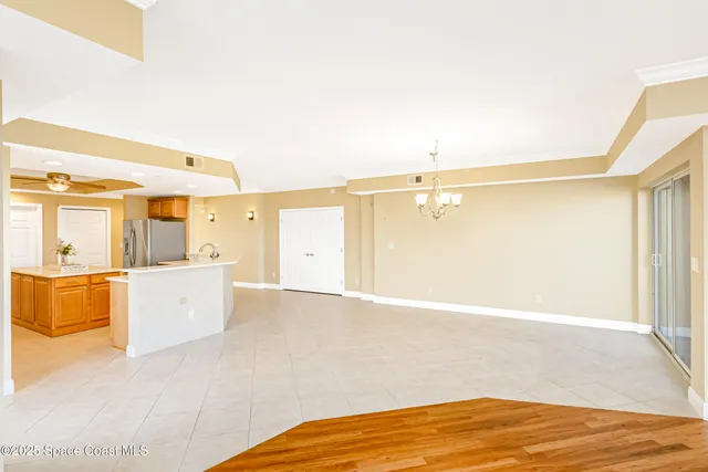 a view of a living room with kitchen view and wooden floor