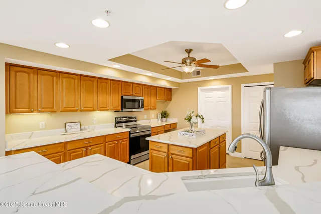a spacious bedroom with a balcony a bed and a flat screen tv