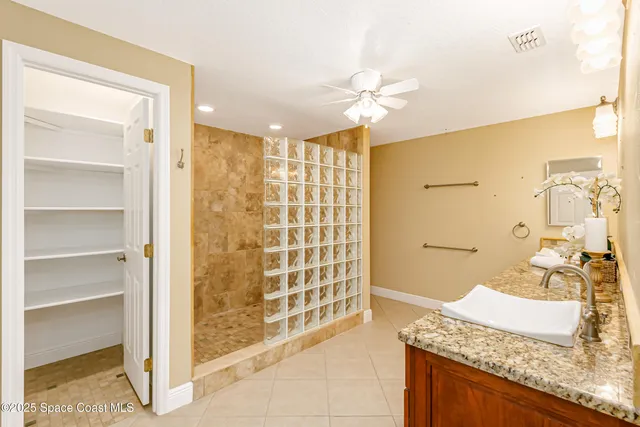 a view of a livingroom with a ceiling fan and window