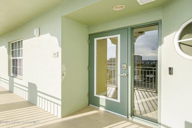 a view of a hallway with wooden floor and a living room