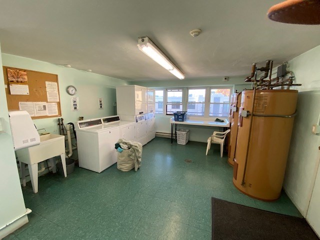 340 Main Street, Unit 501 Melrose, MA 02176 - Photo 11 of 11 a room with furniture a refrigerator and a couch