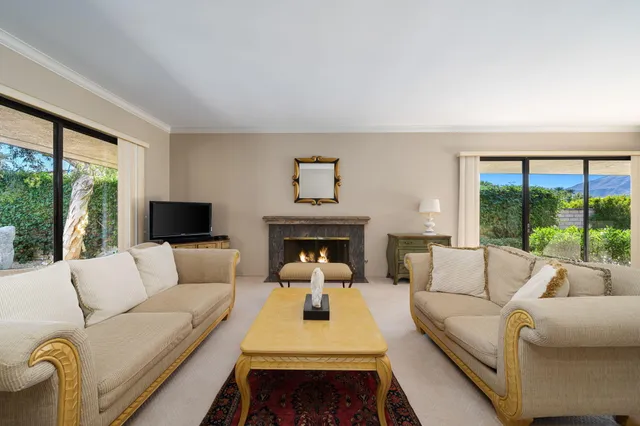 a view of patio with table and chairs and potted plants