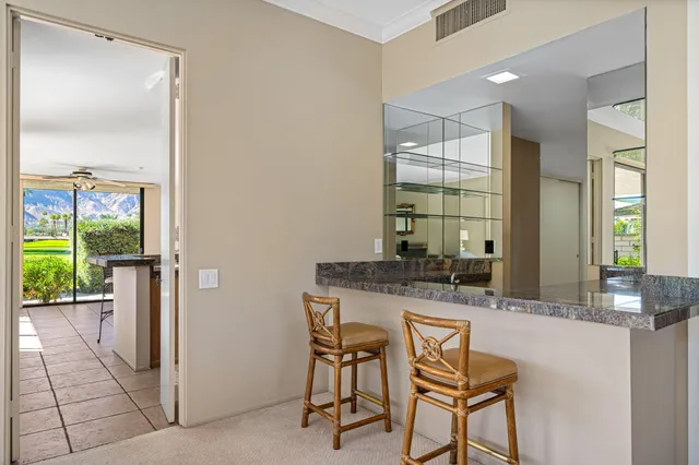 a view of a patio with table and chairs potted plants with wooden floor