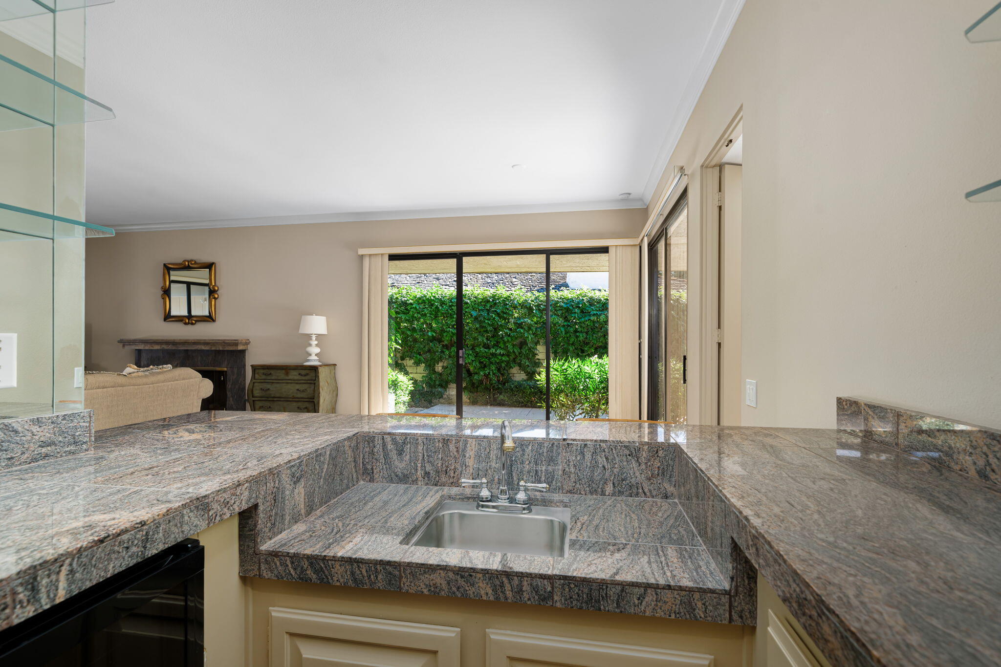 13 Duke Drive Rancho Mirage, CA 92270 - Photo 27 of 68 a kitchen with granite countertop a sink and a counter top space