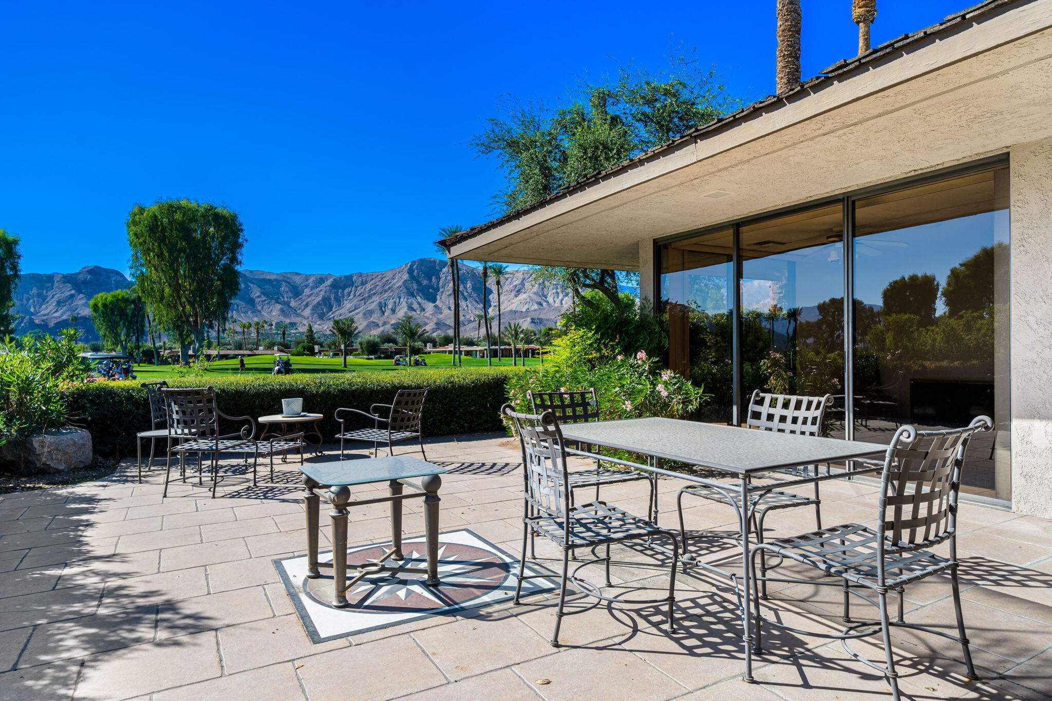 13 Duke Drive Rancho Mirage, CA 92270 - Photo 36 of 68 a patio with table and chairs