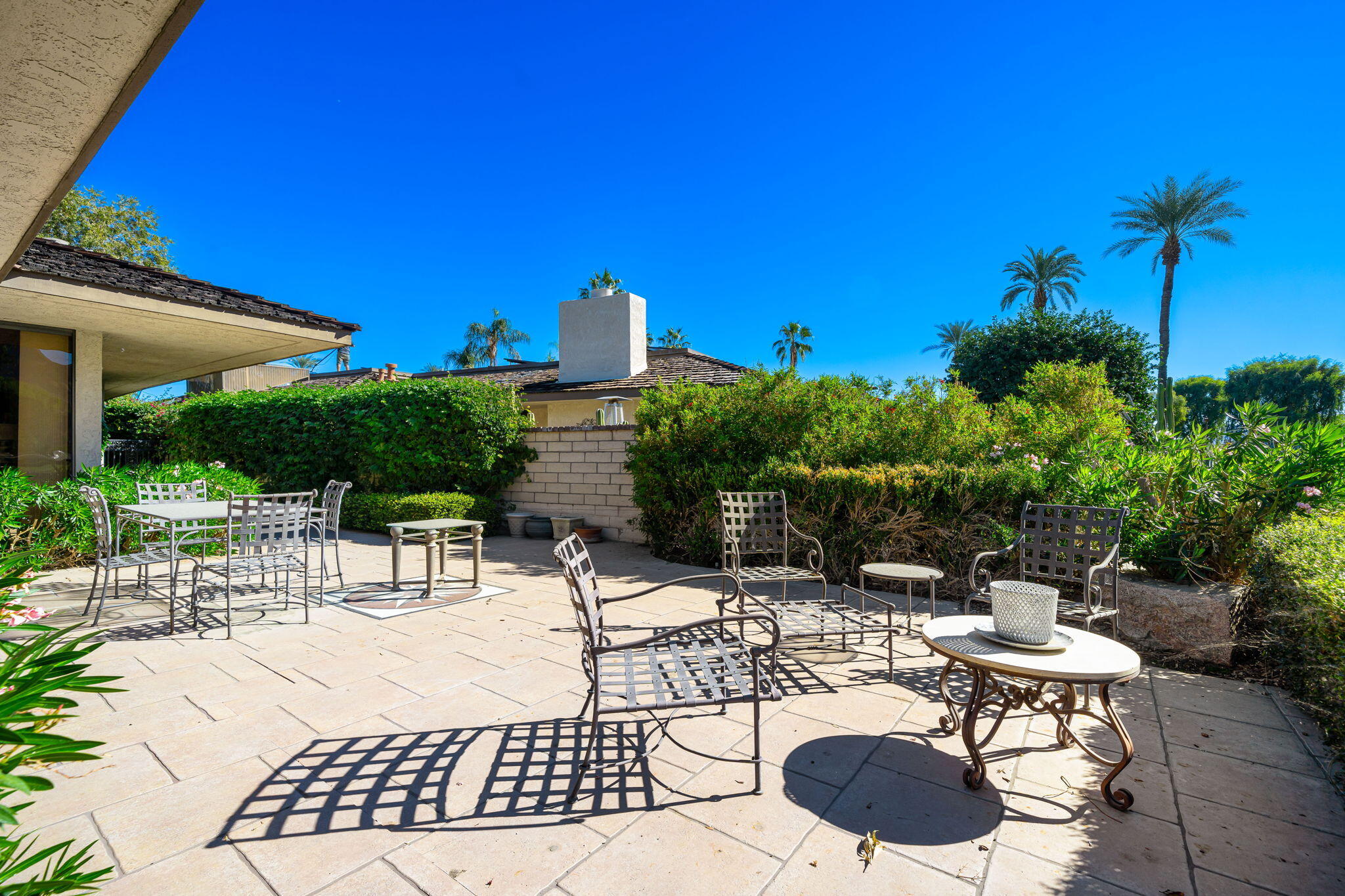 13 Duke Drive Rancho Mirage, CA 92270 - Photo 37 of 68 a view of a patio with table and chairs potted plants with wooden floor