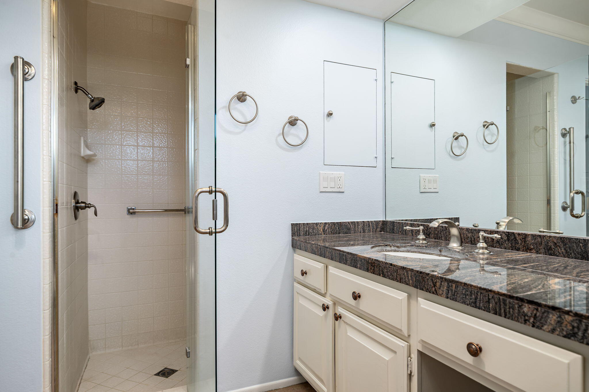13 Duke Drive Rancho Mirage, CA 92270 - Photo 43 of 68 a bathroom with a granite countertop sink two mirror and shower