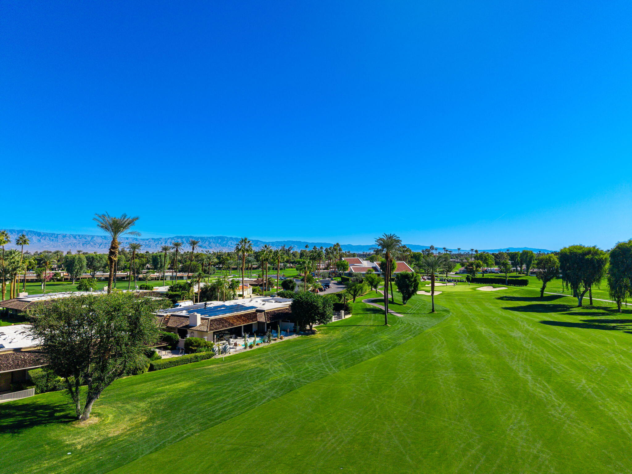 13 Duke Drive Rancho Mirage, CA 92270 - Photo 10 of 68 a view of a grassy field with benches