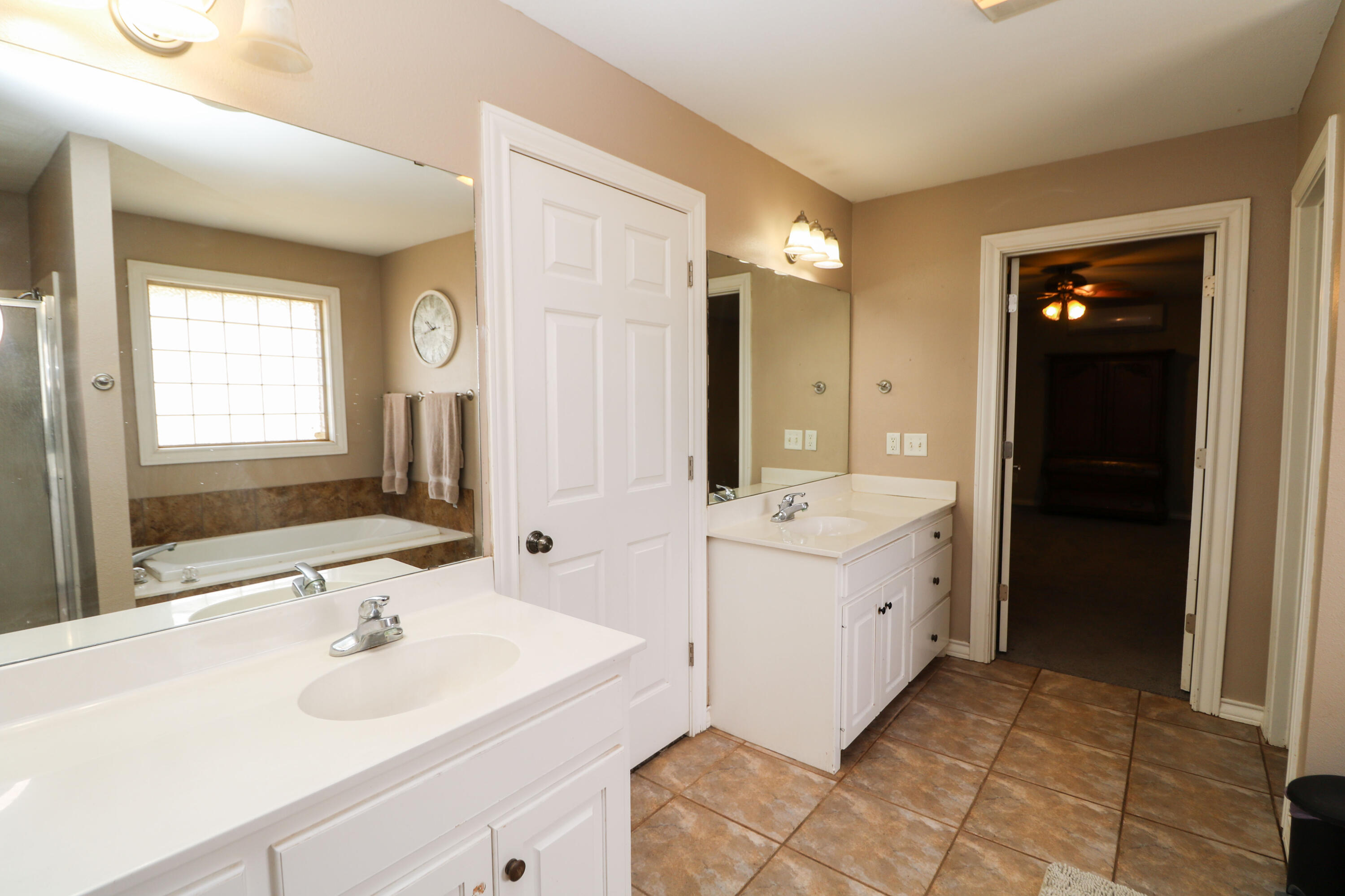 2401 Highway 385, Unit B Littlefield, TX 79339 - Photo 12 of 28 a spacious bathroom with a double vanity sink mirror and bathtub