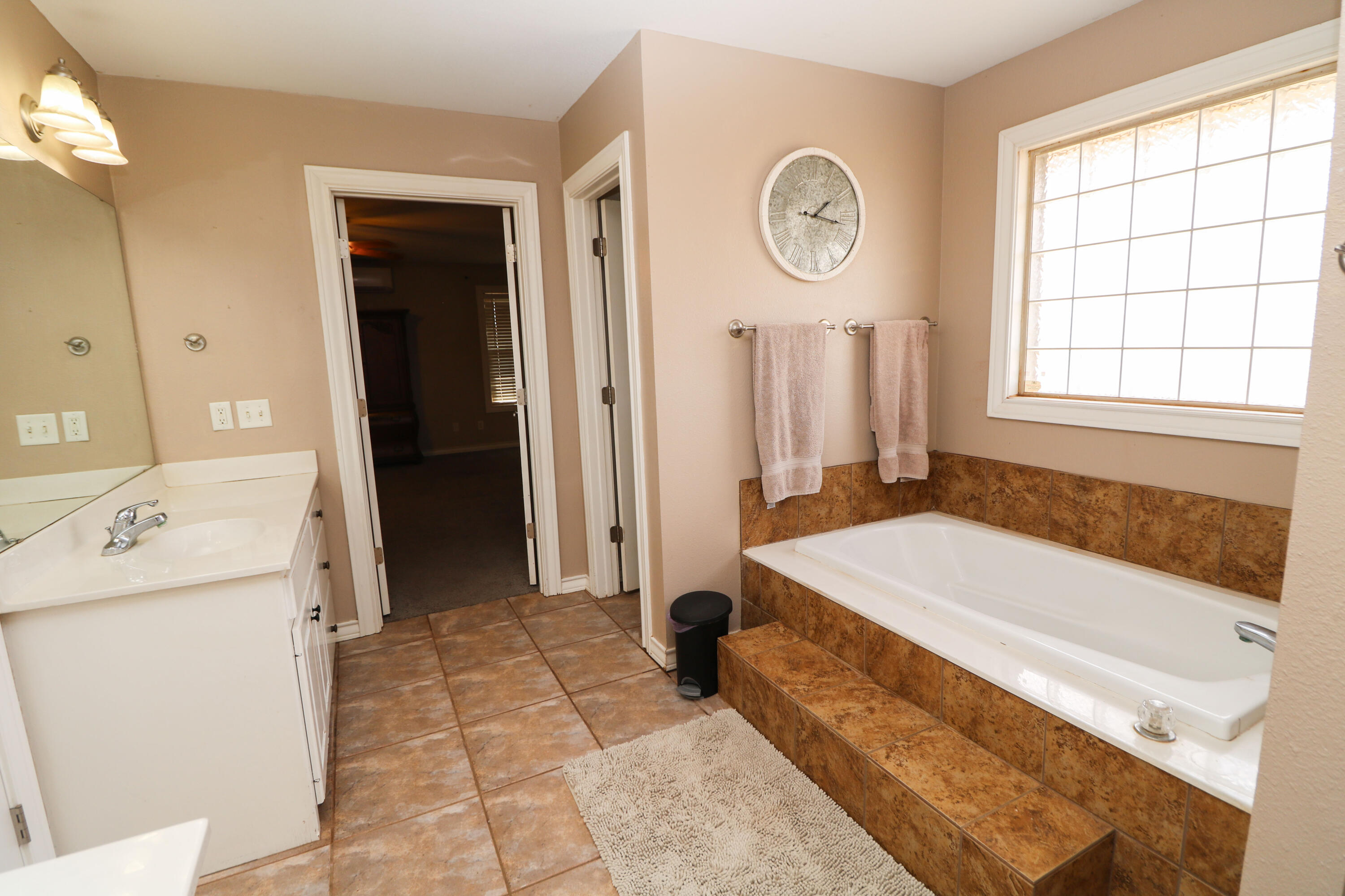 2401 Highway 385, Unit B Littlefield, TX 79339 - Photo 13 of 28 a spacious bathroom with a tub and a sink