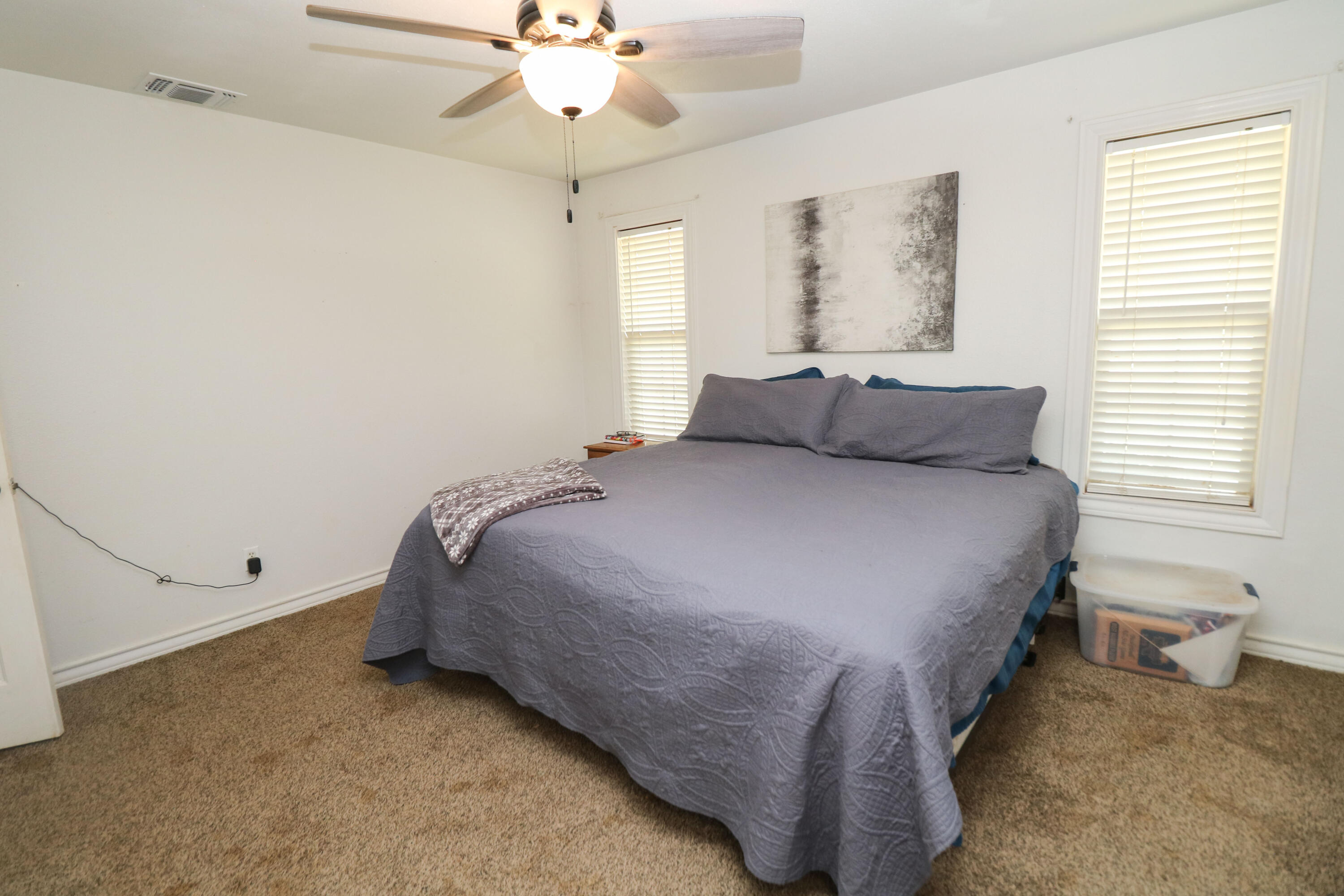 2401 Highway 385, Unit B Littlefield, TX 79339 - Photo 15 of 28 a bedroom with a bed and a chandelier