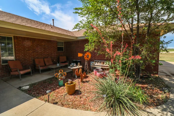 a view of a patio with table and chairs and potted plants