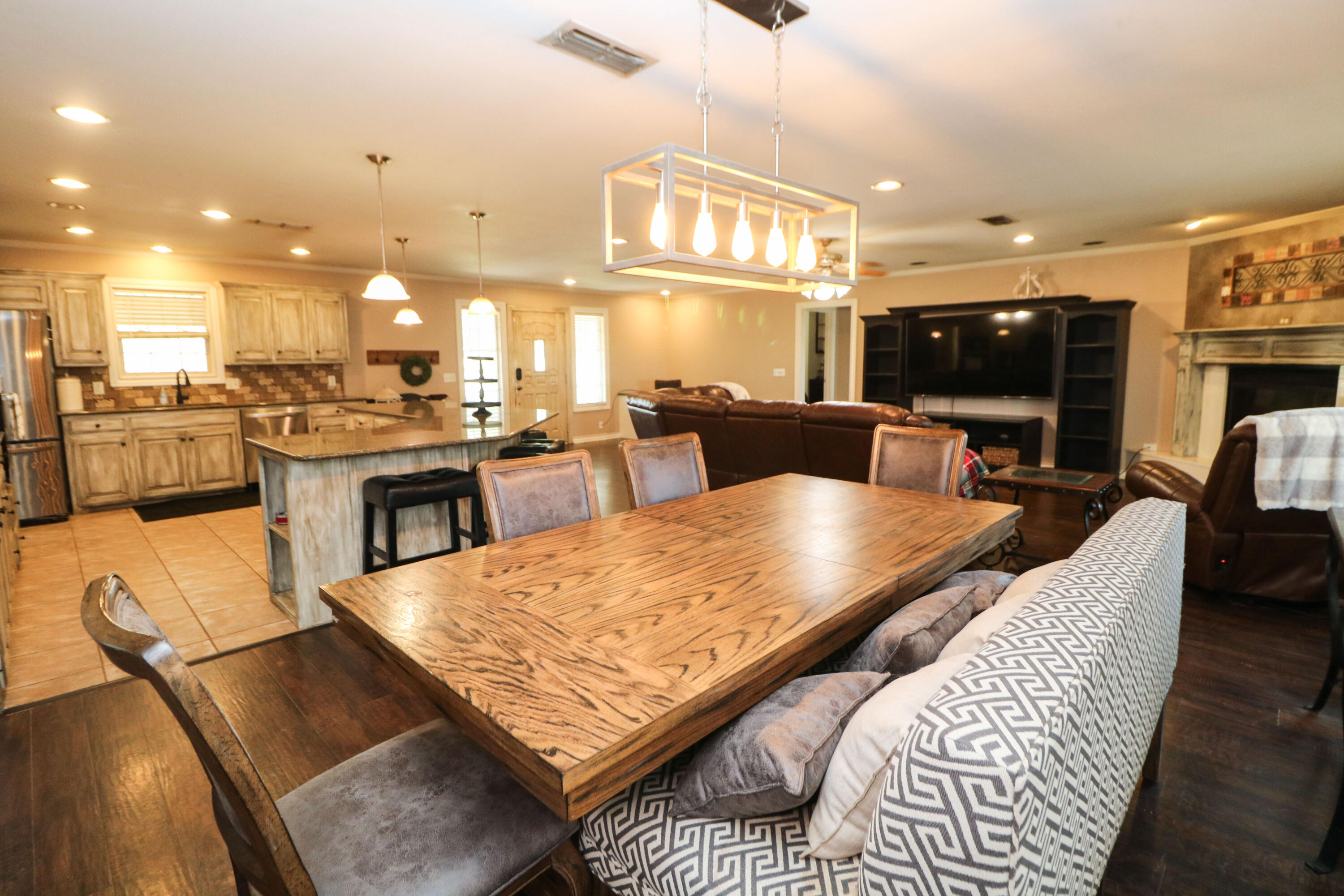 2401 Highway 385, Unit B Littlefield, TX 79339 - Photo 7 of 28 a living room with furniture a flat screen tv and kitchen view