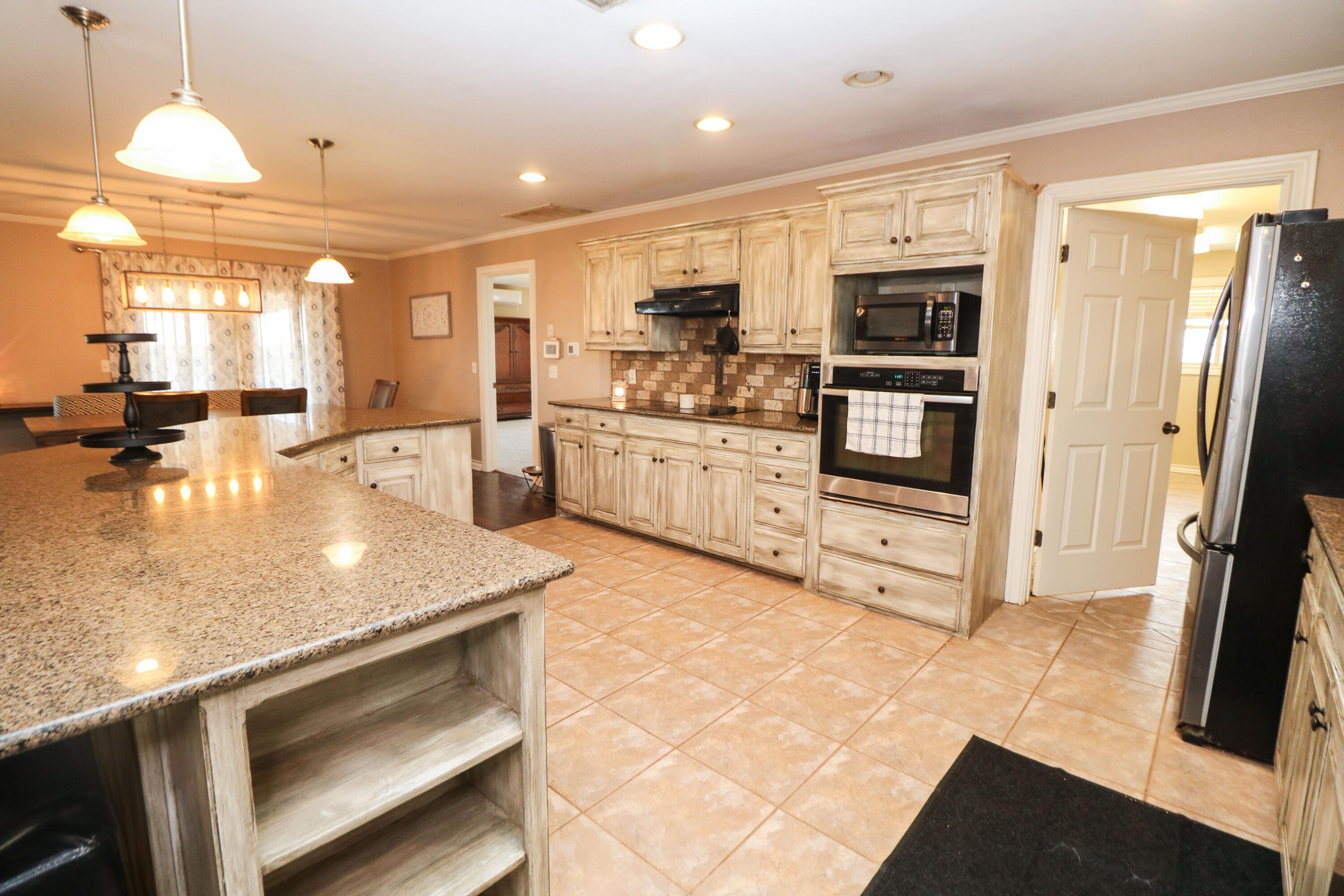 2401 Highway 385, Unit B Littlefield, TX 79339 - Photo 10 of 28 a kitchen with stainless steel appliances granite countertop a refrigerator and a stove